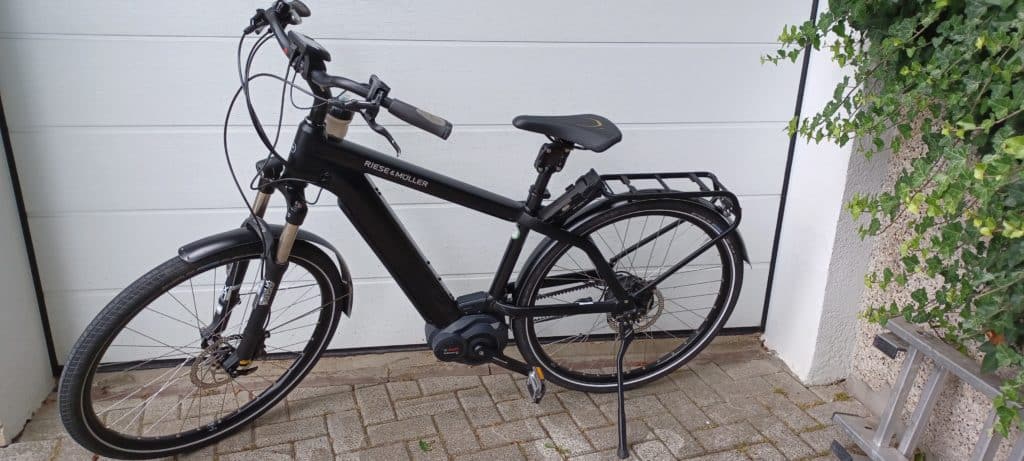 Riese und Müller e-Bike in Schwarz vor einem Tor